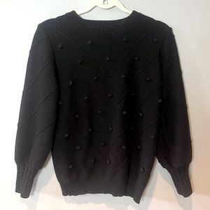 Black sweater with polka dot detailing on front